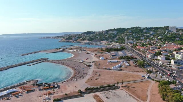 Marseille, France: Aerial view of Marina Olympique, main marina for Olympic Summer Games Paris 2024, flags of participating states flutter in wind - landscape panorama of Europe from above
