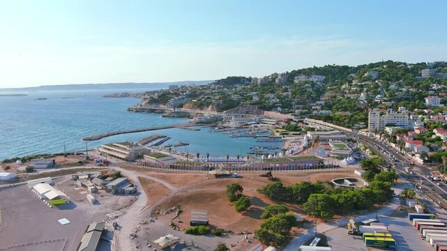 Marseille, France: Aerial view of Marina Olympique, main marina for Olympic Summer Games Paris 2024, flags of participating states flutter in wind - landscape panorama of Europe from above
