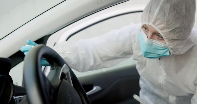 Science, csi and swab for dna evidence in crime scene car for investigation of accident and burglary with hazmat..Forensic, research analysis and person with sample collection for medical observation
