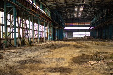 Old factory with objects abandoned inside and growing nature, power of life