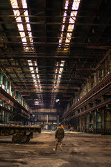 Old factory with objects abandoned inside and growing nature, power of life
