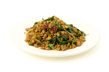 Stir fried Holy basil or Thai basil leaves with minced pork in white plate isolated on white background with clipping path closed up.