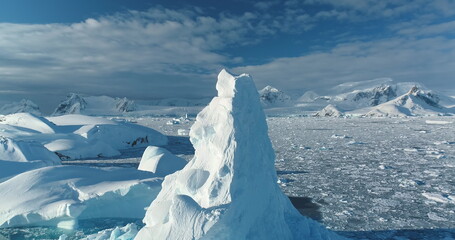 Close up snow covered iceberg peak towering polar ocean. Winter frozen wild nature landscape under...