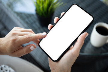 female hands hold phone with isolated screen background cafe office.
