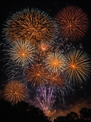 Explosive fireworks light up night sky, creating dazzling display of vibrant colors. Bright oranges, reds, yellows burst forth, cascading like weeping willows.