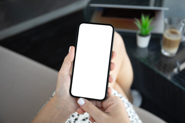 female hands hold phone with isolated screen background cafe office.