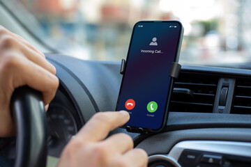 male hands holding phone with incoming call screen in car