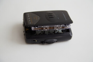 Old black audio player with audio cassette on white background, old technologies, retro music, obsolete technologies