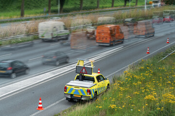 Police car directing traffic on highway. Selective focus