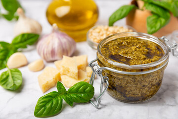 Pesto. Italian basil pesto sauce on a textured wooden background. Ingredient for pesto sauce: fresh...