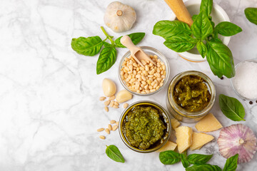 Pesto. Italian basil pesto sauce on a textured wooden background. Ingredient for pesto sauce: fresh...