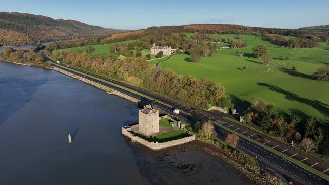 Narrow Water Castle, County Down, Northern Ireland, November 2022. Drone clockwise orbit of Stone Fortress on banks of Newry river with 19th Century Elizabethan Revival Castle in the distance.