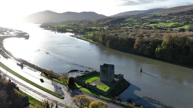 Narrow Water Castle, County Down, Northern Ireland, November 2022. Drone orbits Tower House counter clockwise on a warm sunny morning with Warrenpoint Port and Carlingford Lough in the background.
