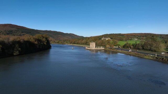 Narrow Water Castle, County Down, Northern Ireland, November 2022. Drone pushes towards the imposing 16th century Tower House above the Newry River on a clear winter morning.