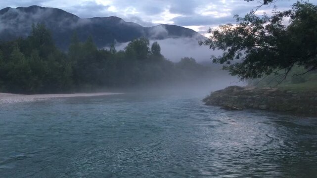 Beautiful Landscape of Soča River, Slovenia, with Fog during a Summer Evening. Tolmin Province, Slovenia