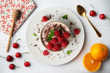 Delicious raspberry mousse with red berries from an overhead perspective.