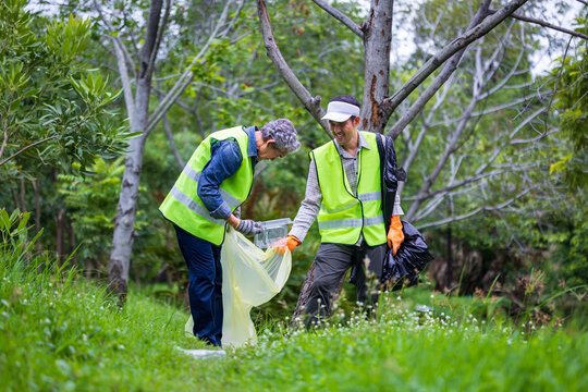 Team volunteer worker group enjoy charitable social work outdoor in cleaning up garbage and waste separation project at the park or natural forest for community service and recycle concept