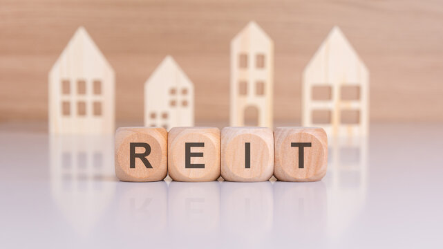real estate reit - Real Estate Investment Trust - explained with blocks and house models for property investment financing