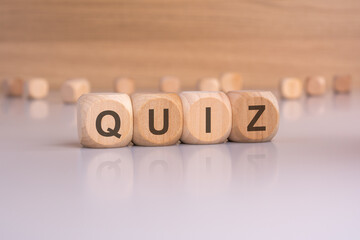 wooden blocks with text quiz, brown background