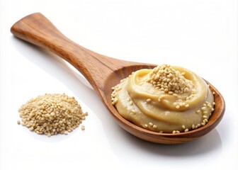 Creamy nut butter or tahini fills a wooden spoon, topped with organic sesame seeds, isolated on a white background, evoking healthy and natural culinary delights.