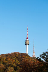 N Seoul Tower with autumn landscape. It is also known as Namsan Tower or Seoul Tower, the landmark which is a communication and observation tower located on Nam Mountain in central Seoul, South Korea