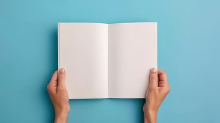 Obraz premium Mockup of a person holding a booklet on a blue background. Offset paper display. A brochure template. Leaflet presentation.