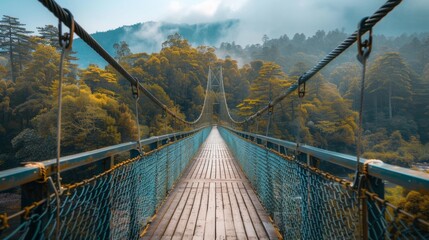 Obraz premium Suspension Bridge in Misty Forest