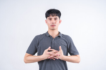 Portrait of handsome Asian man pointing finger up. Marketing and marketing leadership concept on white background.