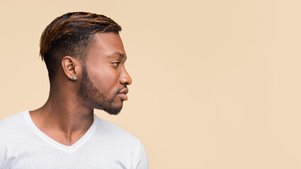 Profile Portrait Of African American Man Standing Over Yellow Studio Background. Panorama, Side View, Copy Space © Prostock-studio