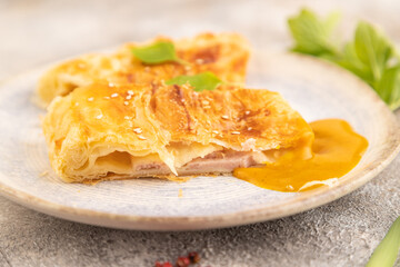 Fried homemade khachapuri cake with cheese and meat, fried in pan. Side view, selective focus