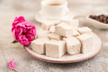 Coffee marshmallow with cup of coffee on brown concrete. side view, selective focus
