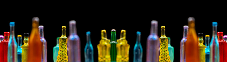 various miniature bottles of alcohol without labels with black bacground