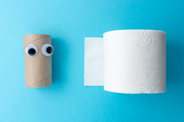 Completed toilet paper roll with googly eyes on pink background. Minimal Coronavirus outbreak. Panic concept.
