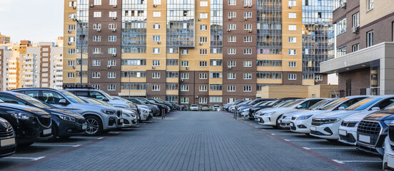 Cars in a parking lot in a new residential area © Yuri Bizgaimer