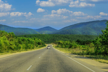car moves along the road in a beautiful mountainous area