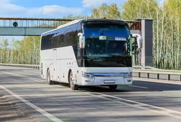 Tourist bus moves along a country highway