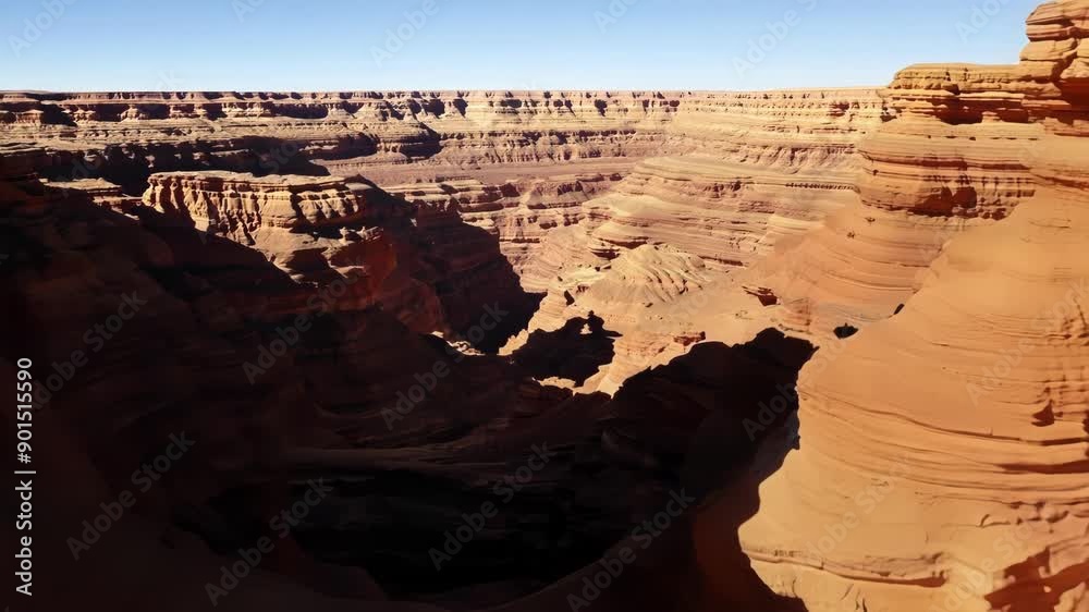 Poster Flying between the deep crevices and canyons of the rocky desert cliffs.