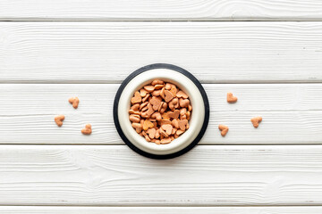 Food and treats for pets - biscuits in a shape of heart in a bowl