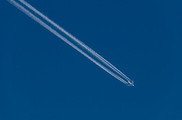 a supersonic plane leaves traces on a clear blue sky