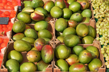 Green ripe mango in a box at the market