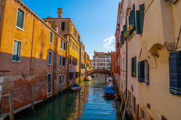 Venice, Italy - June 05, 2024: Peaceful Venice Canal with Docked Boats.