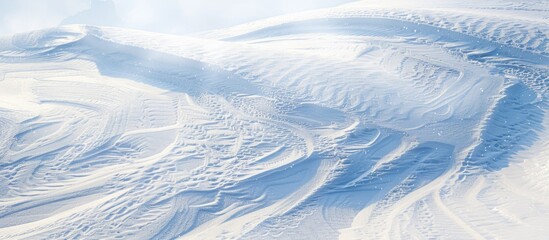 Winter landscape with snow-covered ground creating a stunning natural snow texture and intricate wind-carved patterns, perfect for a copy space image.