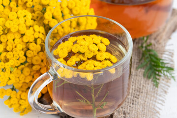 tincture is a decoction of tansy flowers (Tanacetum vulgare) in a glass bottle. Traditional medicine, collection of useful herbs. Alternative medicine