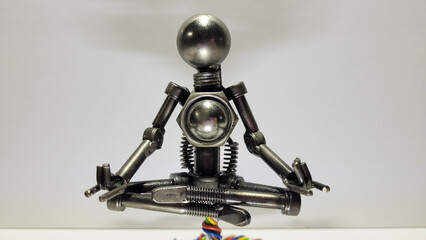 Scrap metal welding art sculpture of Robot Meditating in a Peaceful yoga poses. Zen Robotics deep...