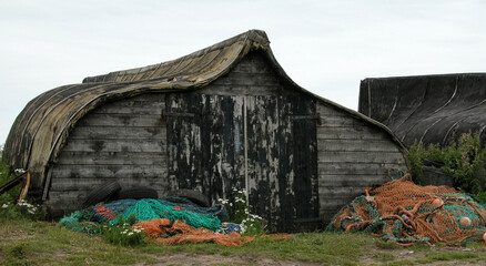 Old ship hull that has been turned into a fisherman's work shed.