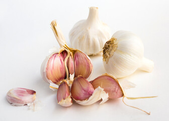 Garlic heads and cloves on white background