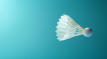 A white badminton shuttlecock suspended mid-air against a vibrant blue background. The shuttlecock appears to be in its standard configuration with a white base and a series of white feathers