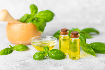Basil essential oil on a textured wooden background. Basil essential oil and fresh leaves. Aromatherapy. Aroma oil. Medical herbs. Alternative medicine. Place for text. Copy space.