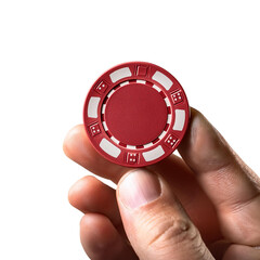 A hand holding a red poker chip symbolizing gambling, luck, and excitement in a casino environment.