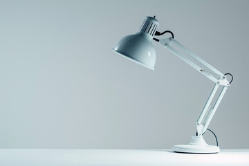 White desk lamp with adjustable arm and a lightbulb on a white table. - Powered by Adobe